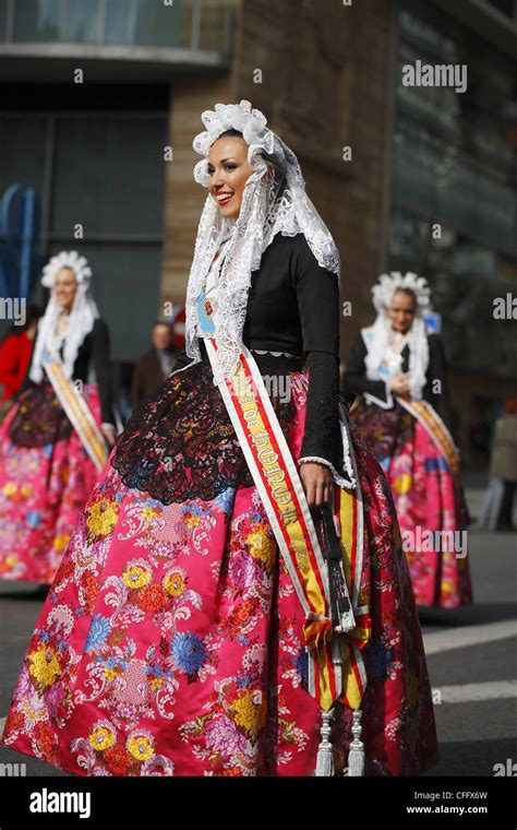 Spanish women wearing traditional clothes during the street procession, Alicante, Spain Stock ...