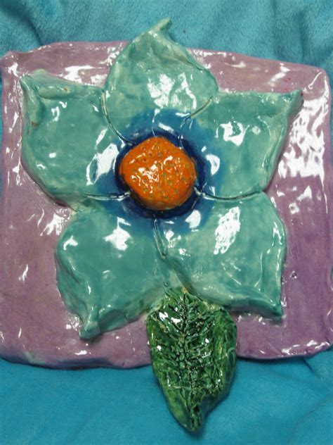 4th grade ceramic flower sculpture; approx. 10"x10"; lesson designed by art teacher: Susan Joe ...