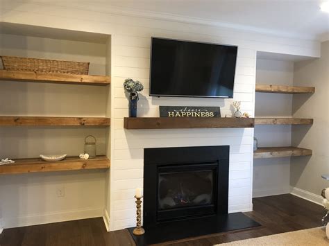 Shiplap wall with floating shelves and new mantle around fireplace ...
