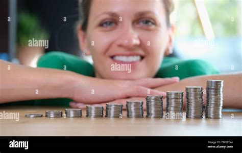 Smiling confident business woman stacked coins on the office table Stock Photo - Alamy
