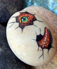 I painted this rock to look like a baby dinosaur peeking out of a broken eggshell. Cute in the ...