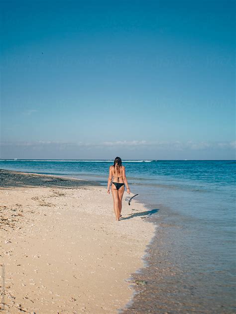 "Girl Walking On The Beach" by Stocksy Contributor "Daniel & Caroline" - Stocksy