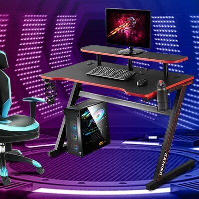 a gaming chair and desk with a computer on it in front of a purple ...