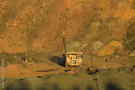 Large yellow quarry dump truck for transporting rock mass in the quarry. Transportation and ...