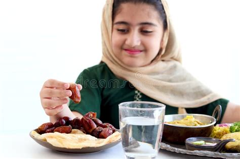 Date Fruit on Hand of Muslim Girl Wearing Hijab and Traditional Costume, Kid with Hijab Holding ...