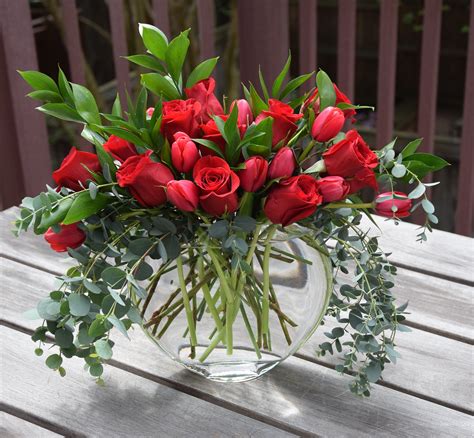 Modern red rose arrangement with eucalyptus and tulips. | Flower arrangements simple, Rose ...