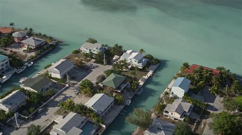 5K stock footage aerial video of flying by homes on canals, Big Coppitt Key, Florida Aerial ...