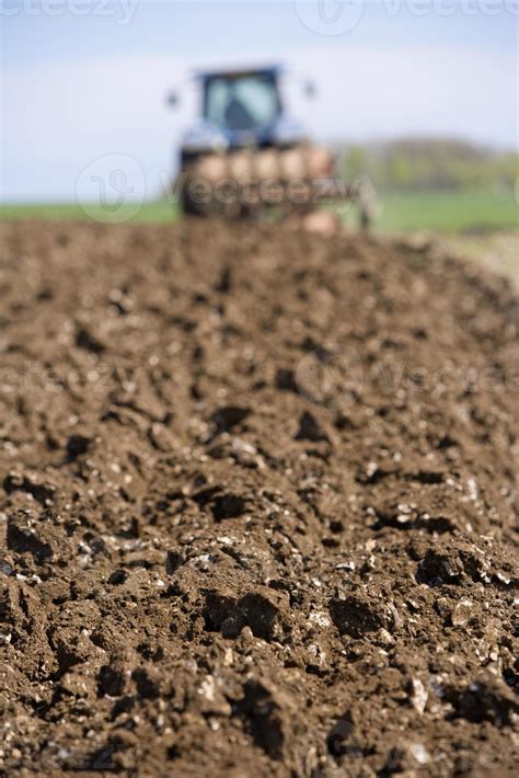 Close up of ploughed field with tractor and plough 797327 Stock Photo at Vecteezy