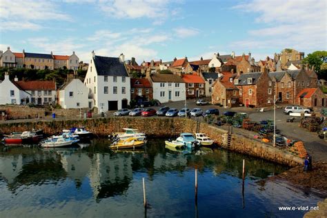 Crail, Scotland - Amazing blue sea water showing reflection of colorful village houses ...
