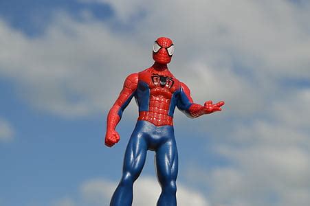 Royalty-Free photo: Spider-Man action figure under blue and white cloudy sky | PickPik