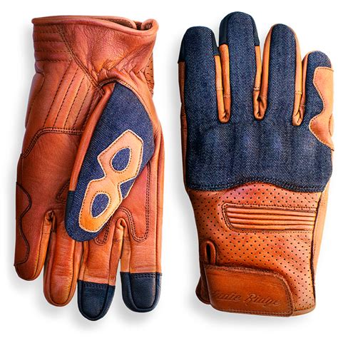 a pair of brown leather gloves with blue and orange stitching on the palm, sitting next to each ...