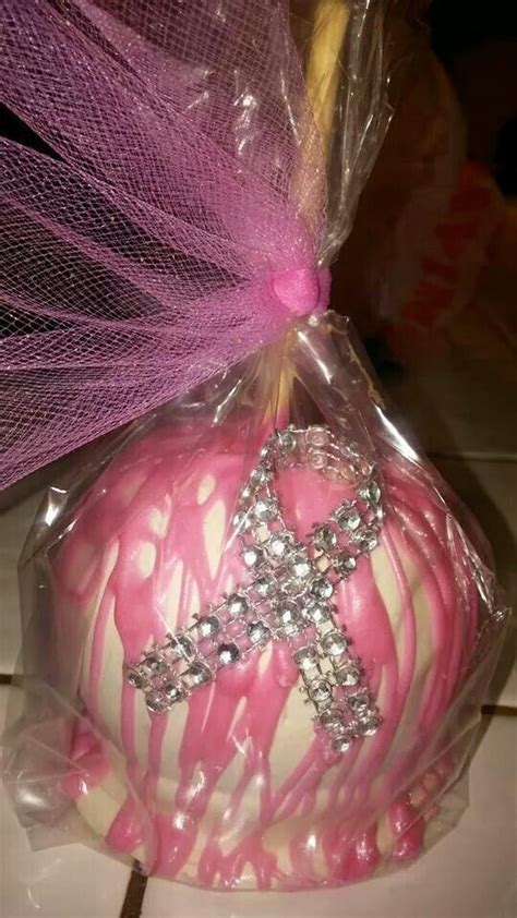 a pink and white cake in a bag with a cross on it's side