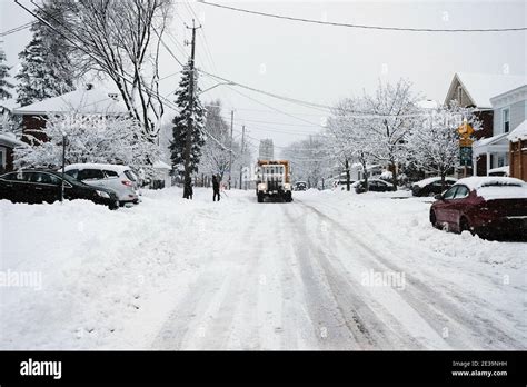 A yellow City of Ottawa snow plow truck roams the Glebe streets during ...