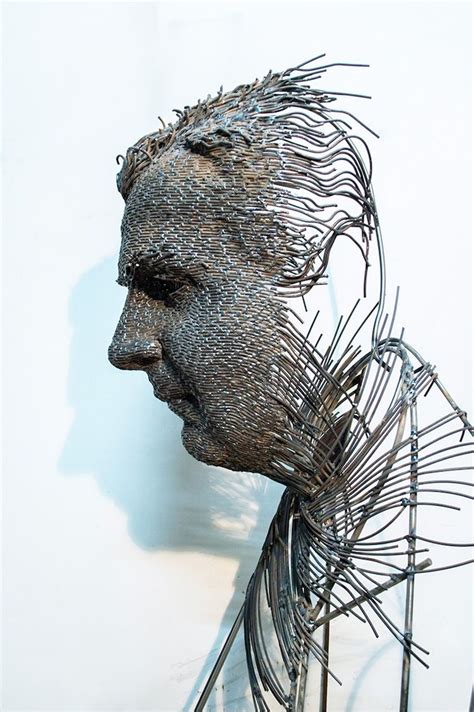 a metal sculpture of a man's face and hair