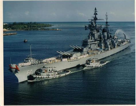 an aircraft carrier is in the middle of the ocean with another ship ...