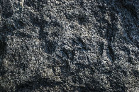 Raw gray granite rock texture background. Fragment of natural stone wall. Cracked, backdrop ...