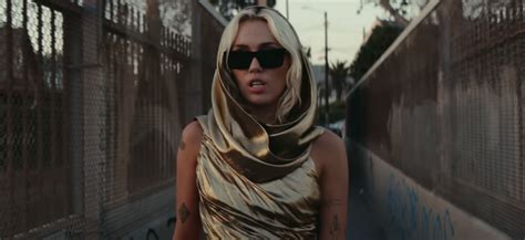 Miley Cyrus Wears Gold Cutout Dress in "Flowers" Music Video | POPSUGAR Fashion UK