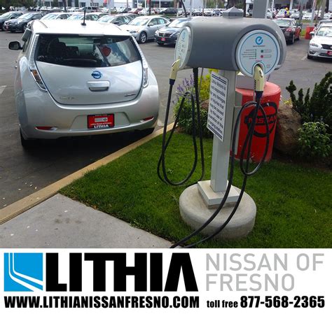 Nissan LEAF and charging station at the dealership.