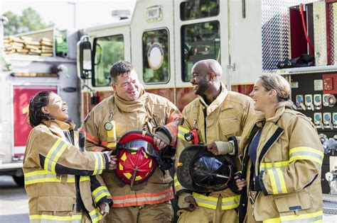 Team of firefighters standing in front of fire truck | Deborah Specialty Physicians