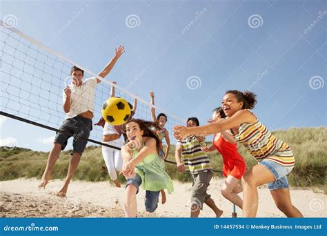 Teenage Friends Playing Volleyball On Beach Stock Images - Image: 14457534