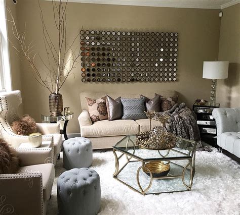 a living room filled with lots of furniture next to a wall mounted art ...