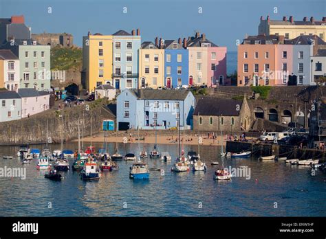 Tenby Harbour with boats at high tide at sunset Tenby Dinbych-y-Pysgod ...