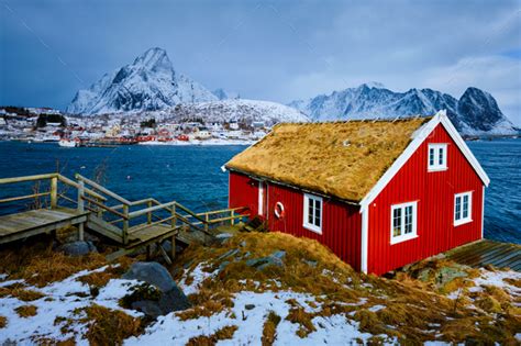 Traditional red rorbu house in Reine village on Lofoten Islands Stock Photo by f9photos