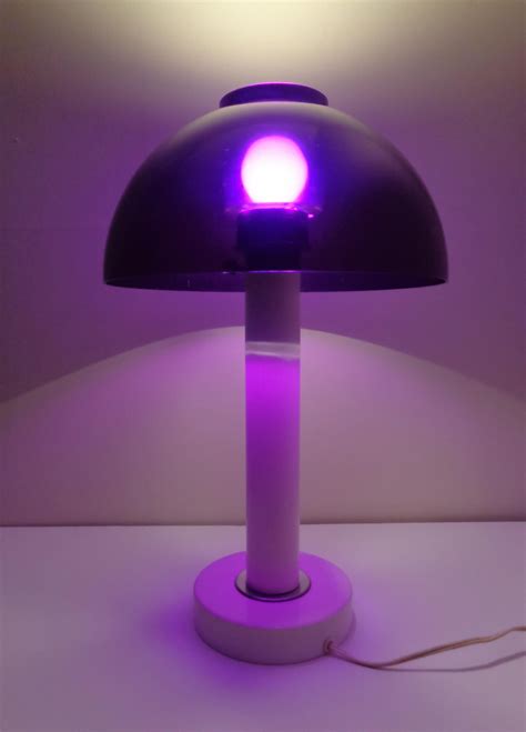 a purple lamp sitting on top of a white table