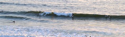 Surfers in the ocean catching the dual breaking wave Encinitas, Surfers ...