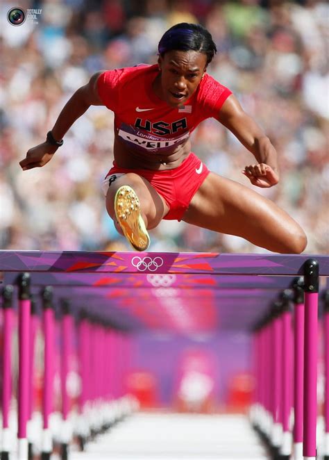 Kellie Wells of the U.S. clears a hurdle during her women's 100m hurdles round 1 heat during the ...