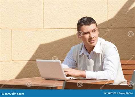 Man Using a Laptop Outdoors Stock Photo - Image of sitting, searching: 19467108