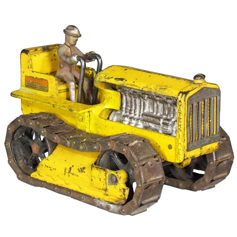 a yellow toy tractor with a man sitting on it