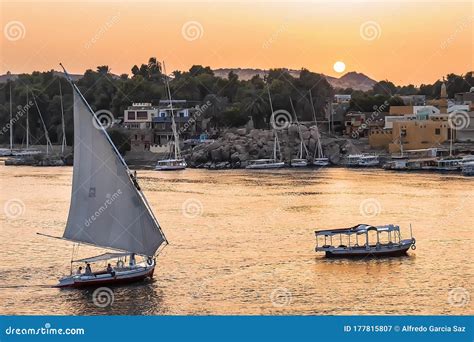 Felucca Boat Sailing on the Nile River at Sunset in Aswan, Egypt Stock Image - Image of city ...