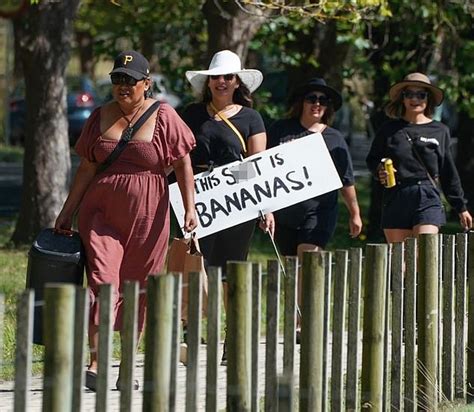 Jacinda Ardern's wedding day is picketed by anti-vax protestors as new details of her dress ...