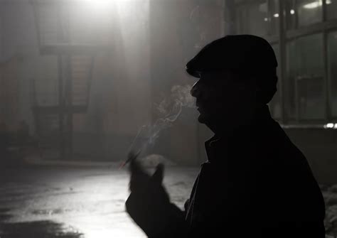 Silhouette of Man Smoking Cigarette · Free Stock Photo