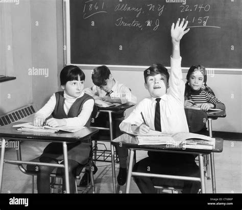 Vintage image of boy raising hand in classroom Stock Photo - Alamy