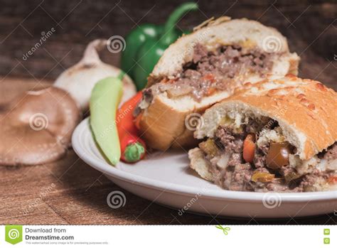 Venison Stuffed French Bread Loaf on a White Plate in Rustic Set Stock Photo - Image of cheese ...