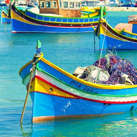 there are many colorful boats in the water