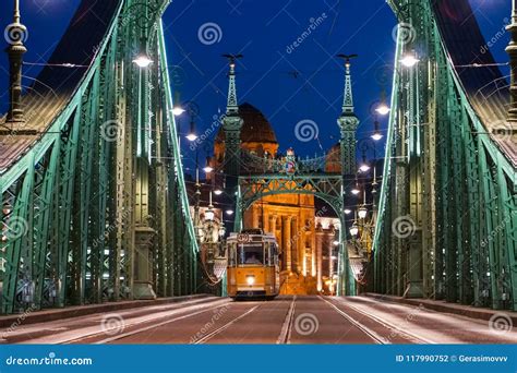 Night View of a Liberty Bridge Szabadsag Hid with a Moving Tra ...