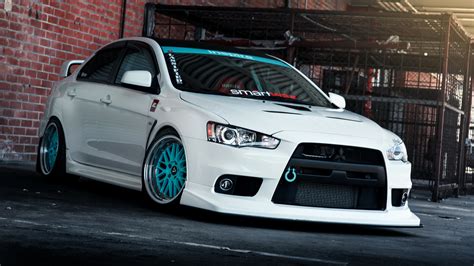 White Tuning Mitsubishi Lancer Evo X with blue wheels