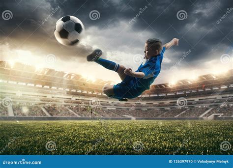 Young Boy with Soccer Ball Doing Flying Kick at Stadium Stock Photo - Image of people ...