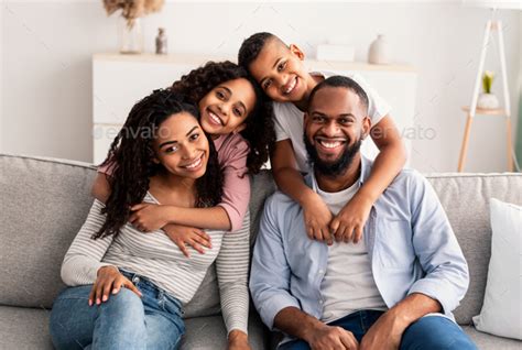 Portrait of a happy black family posing at camera Stock Photo by ...