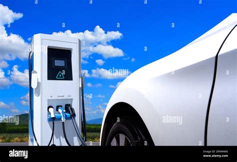 Electric car charging station with blue sky and clouds background. EV ...