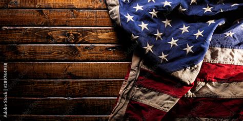 Old and worn American flag on dark wooden background Stock Photo | Adobe Stock