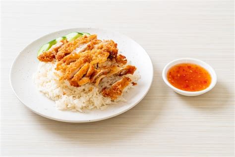 Premium Photo | Hainanese chicken rice with fried chicken or rice ...