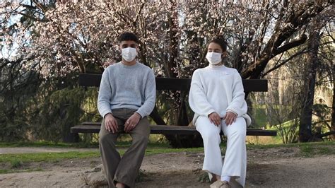 Man and Woman Wearing Facemask While Sitting with Social Distancing · Free Stock Video