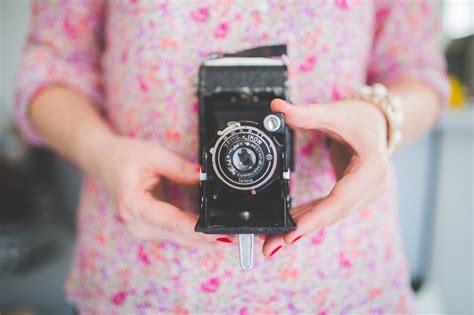 Old analog camera in woman's hands · Free Stock Photo