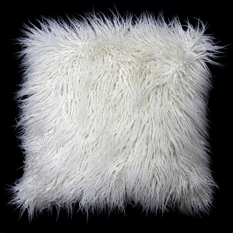 a white furry pillow on a black background