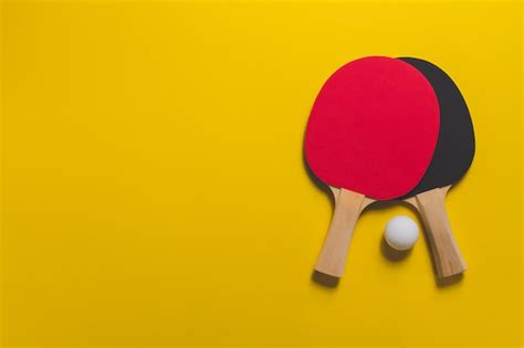 Table tennis rackets on yellow surface | Free Photo