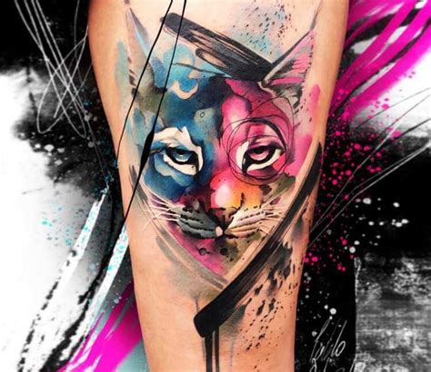 a colorful cat tattoo on the leg with paint splatters and black lines ...